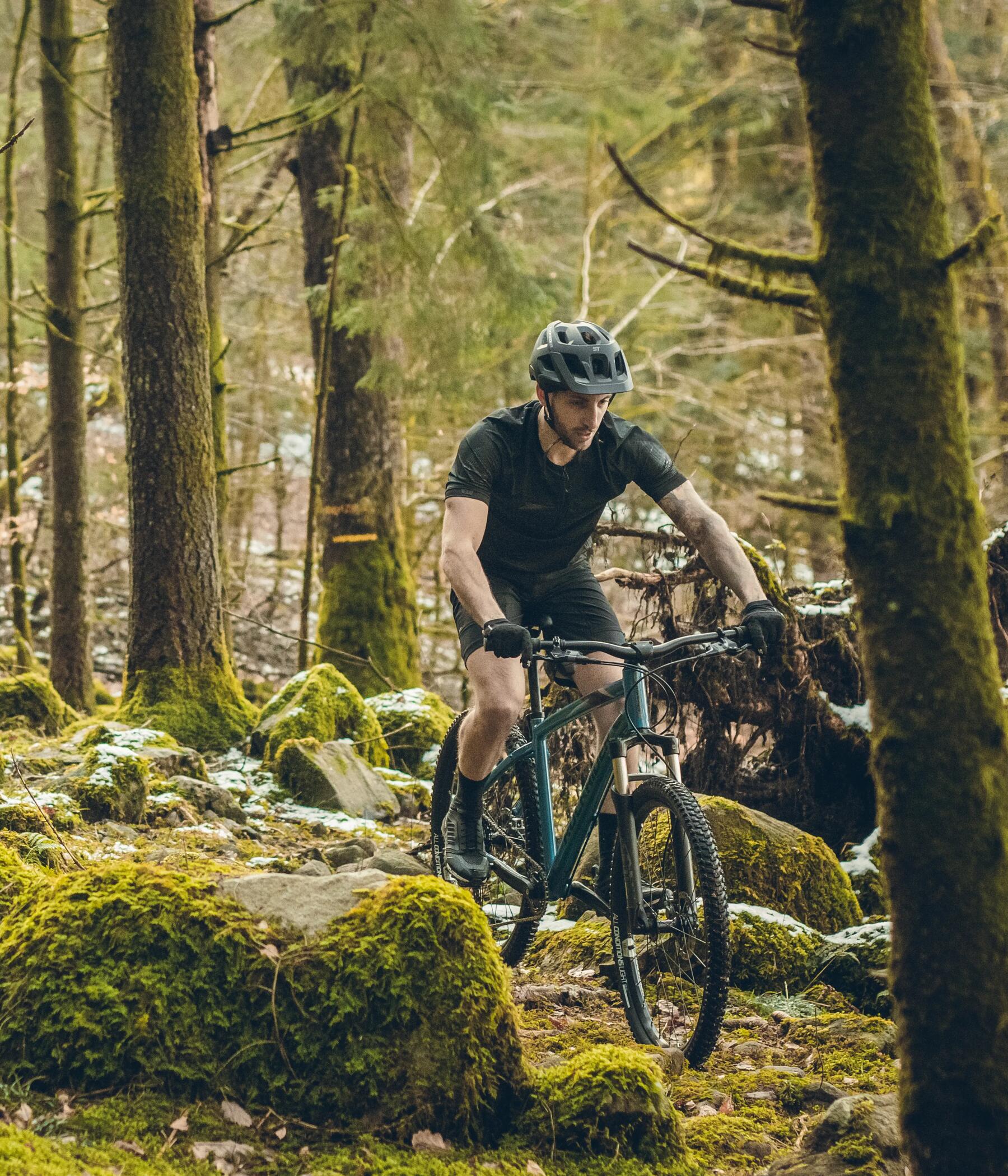 mężczyzna jadący na rowerze MTB w kasku 