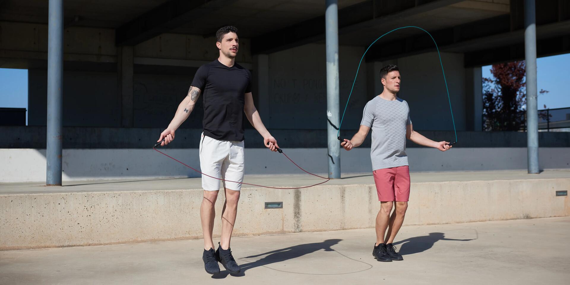 Two men skipping outdoors.