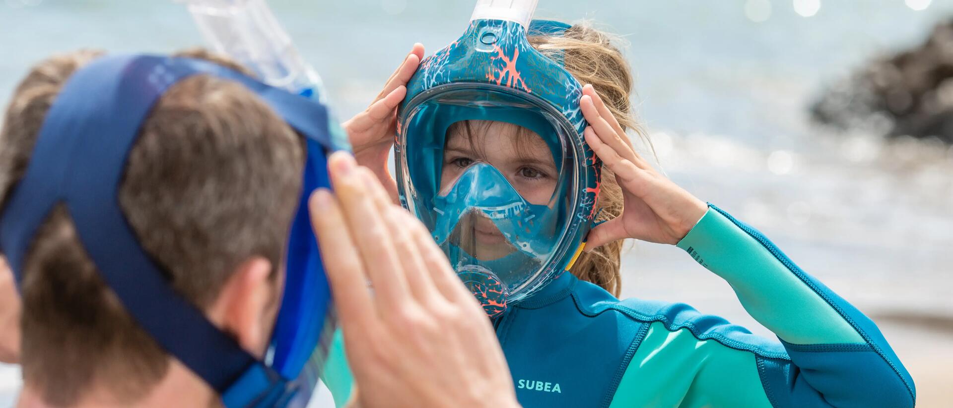 Father teaching his daughter to fit on an easybreath mask