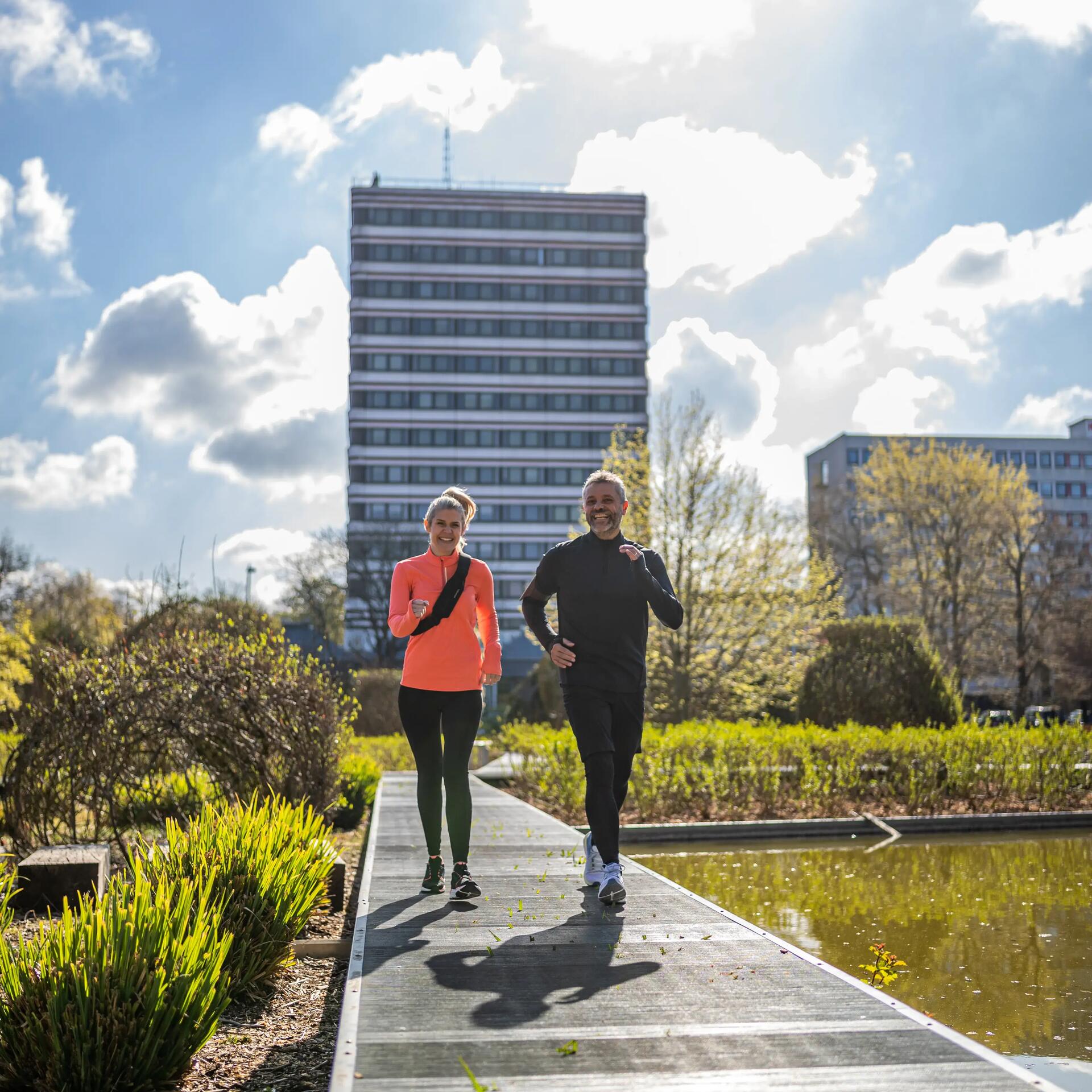 A man and woman power walking.