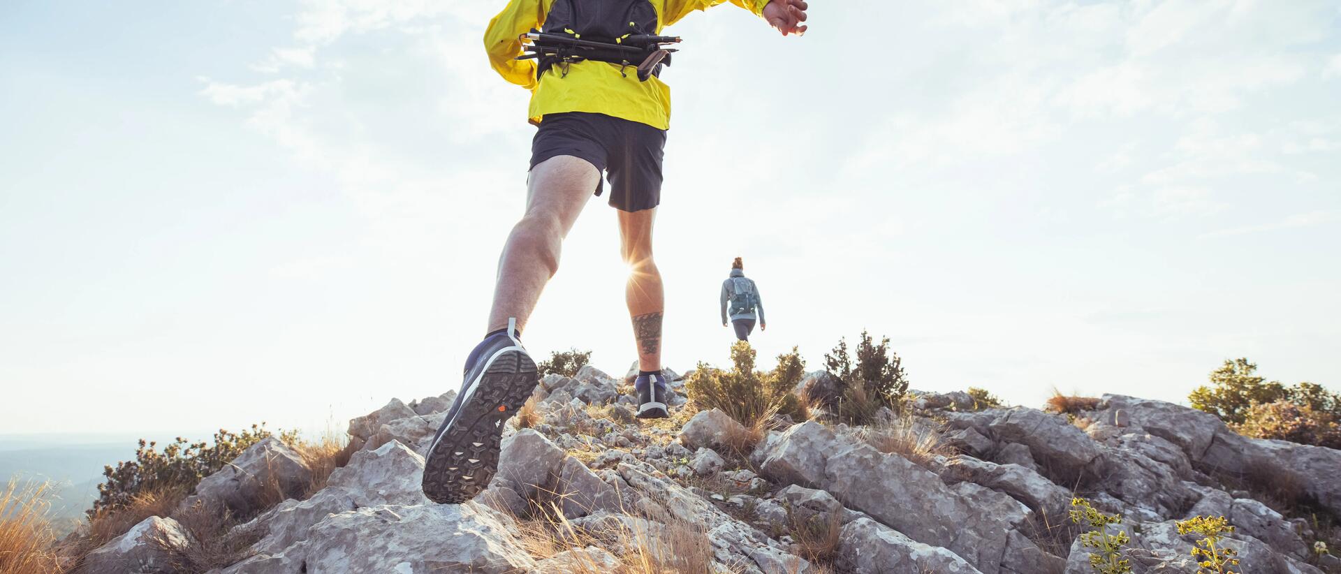 Man and woman hiking during sunrise.