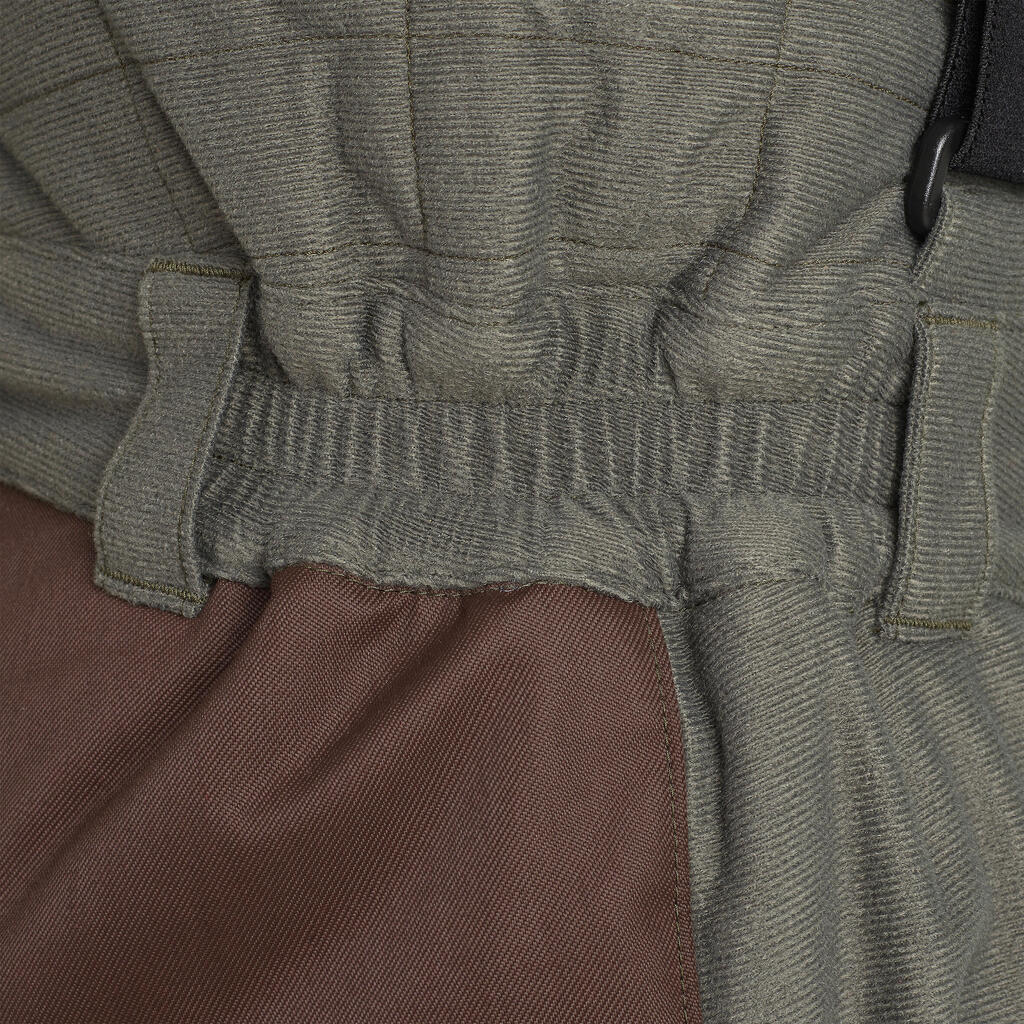 Hrejivé poľovnícke nohavice 100 s trakmi do -20 °C zelené