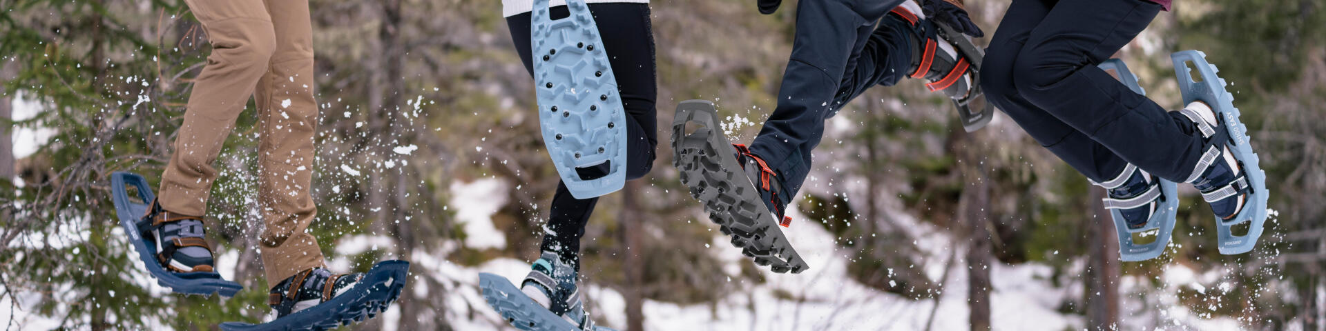 people jumping while wearing snowshoes