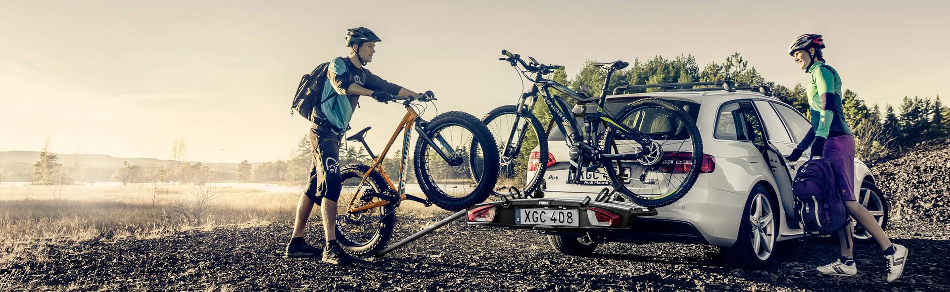 Rowerzyści montujący rowery na bagażniku rowerowym na hak