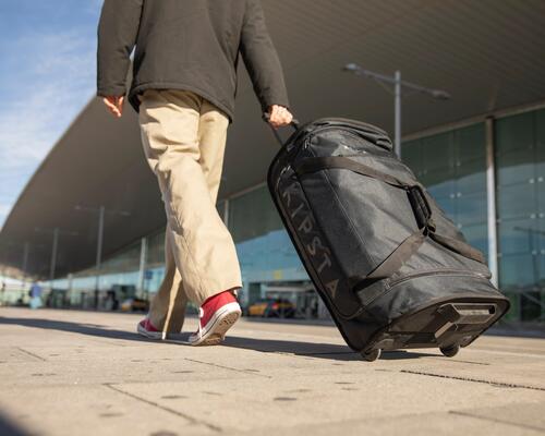 Person walking with a kipsta suitcase