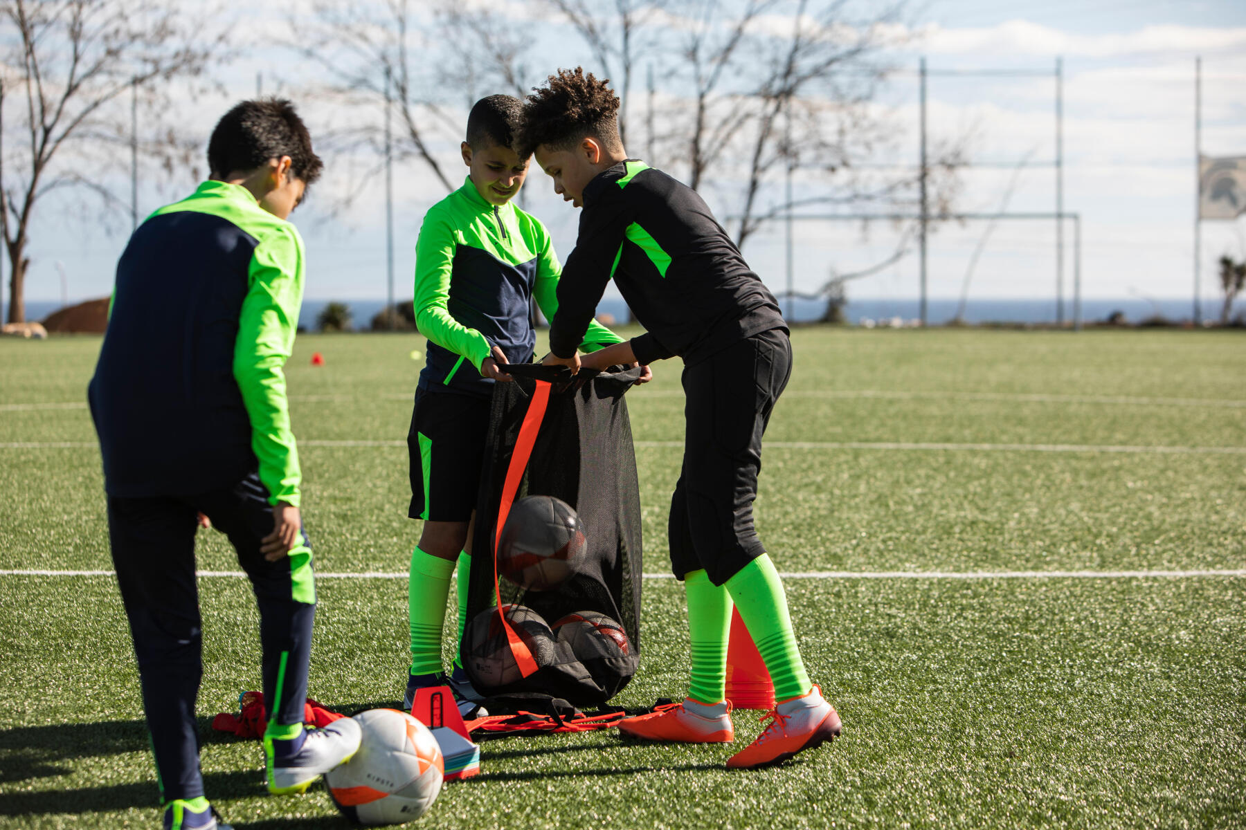 children packing soccer balls