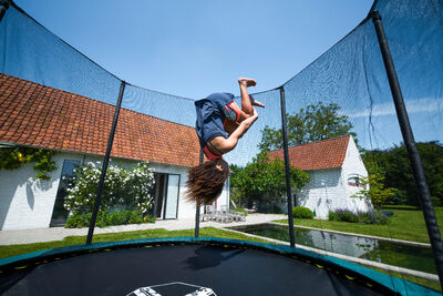 kid jumping on the trampoline