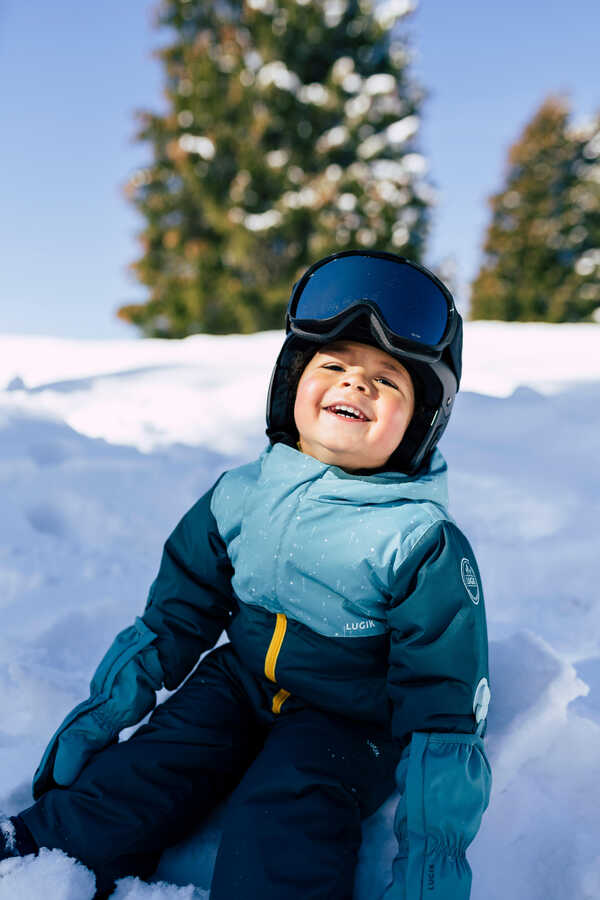 A child wearing a ski outfit