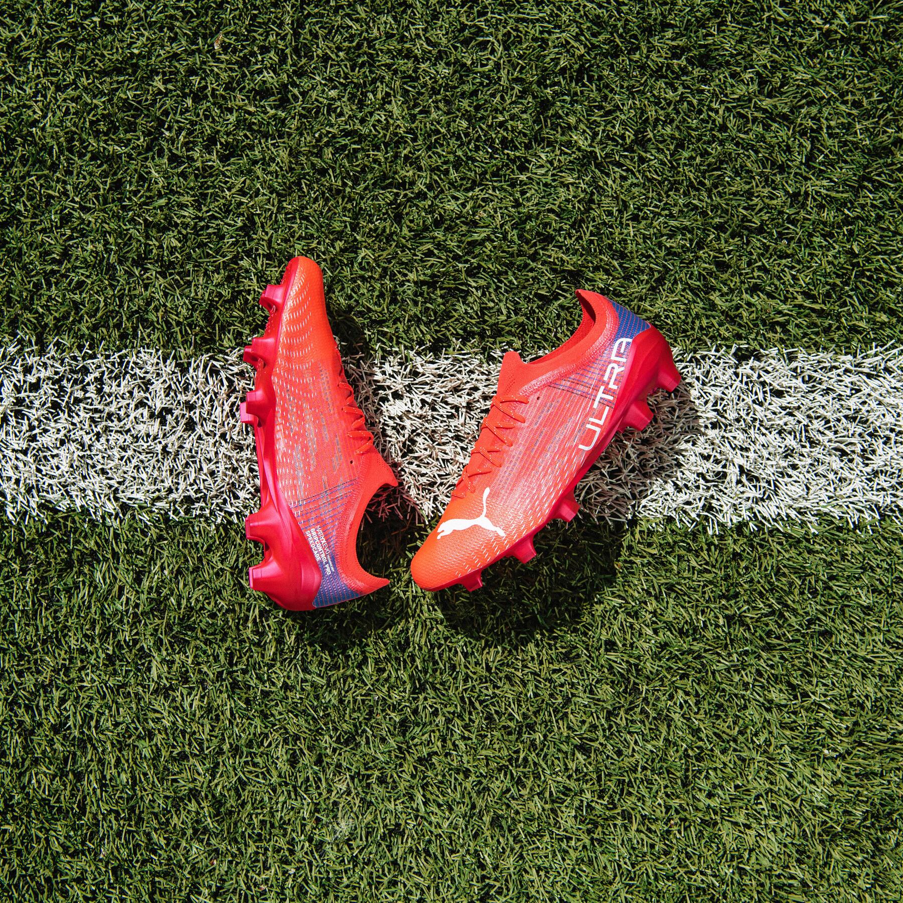 Czerwone korki piłkarskie leżące na murawie