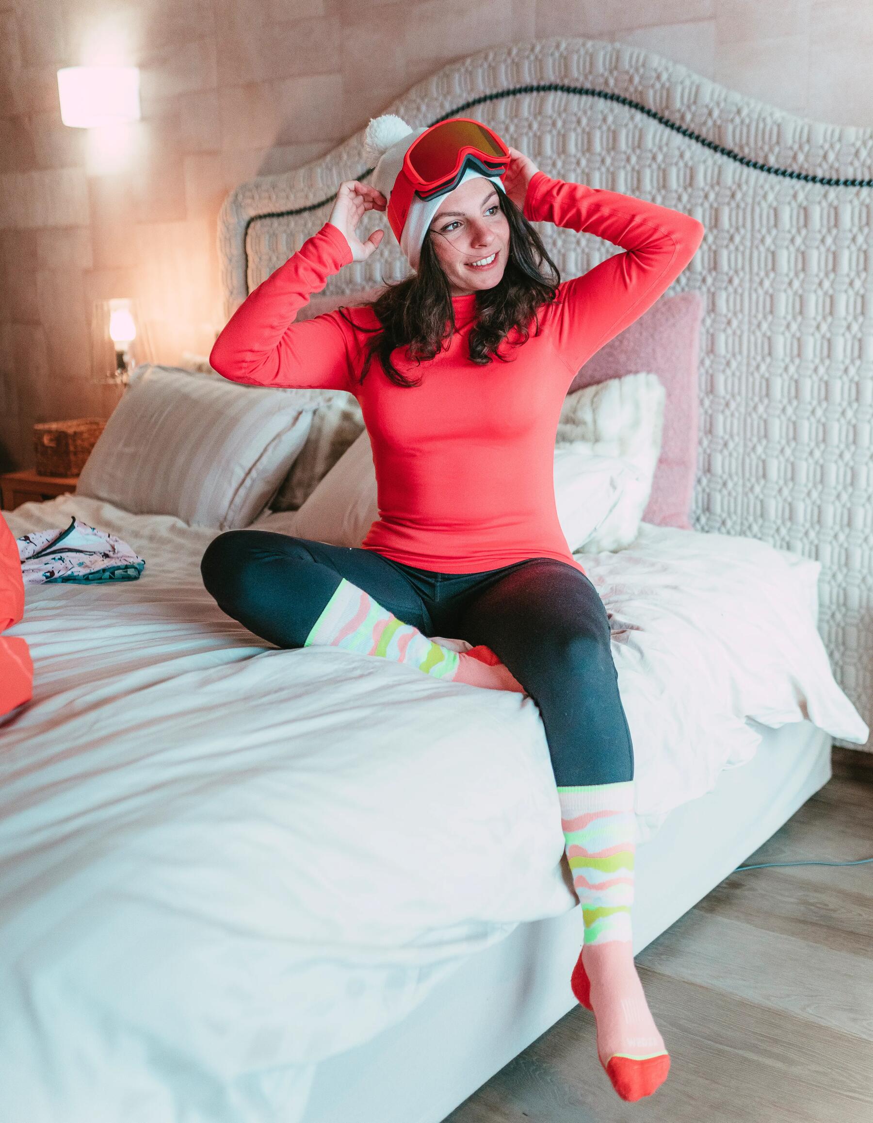 Woman wearing ski socks on bed