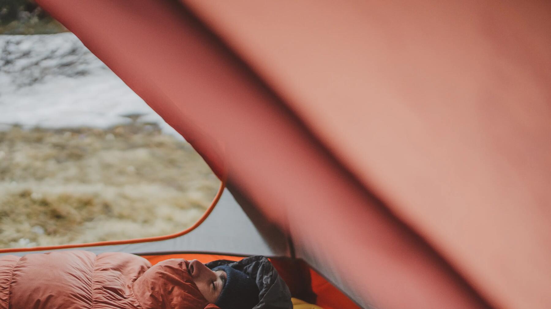 A middle-aged couple sleeping in a tent