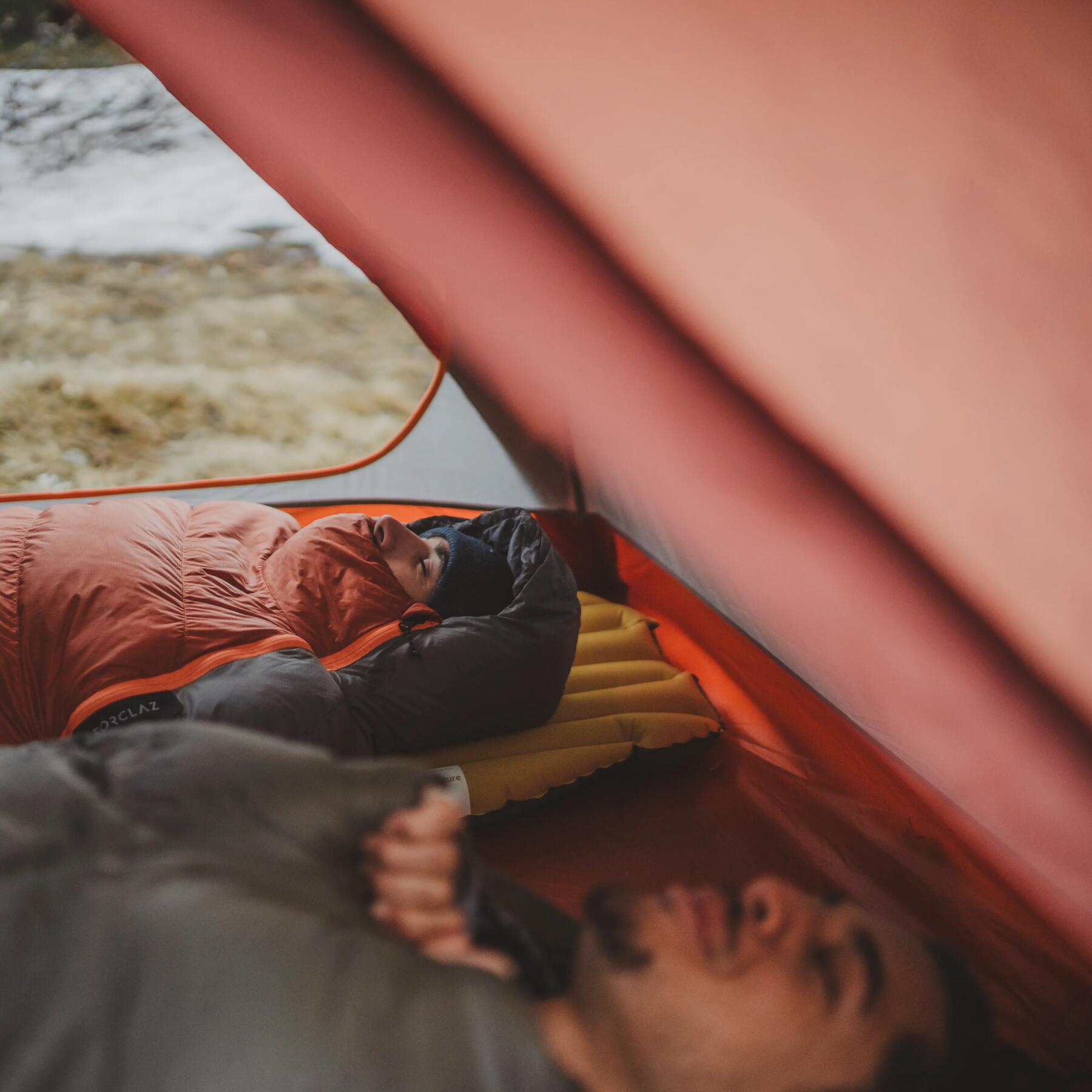 A middle-aged couple sleeping in a tent
