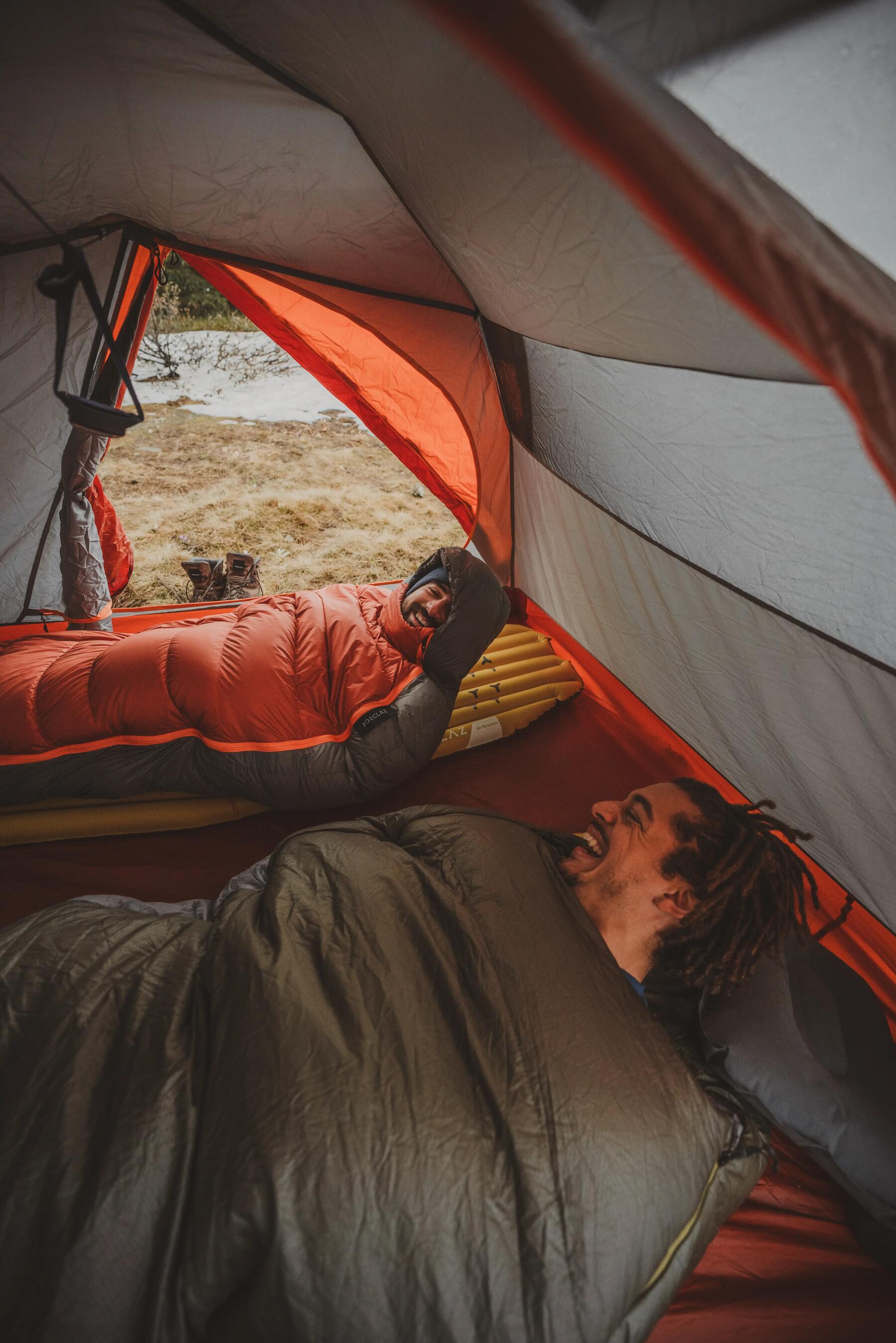 Man sleeping soundly on a camp bed  inside a tent