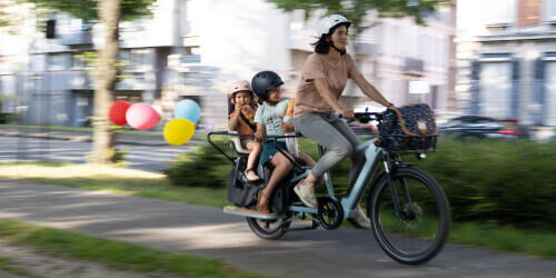 Mãe com filhos a fazer passeio de bicicleta