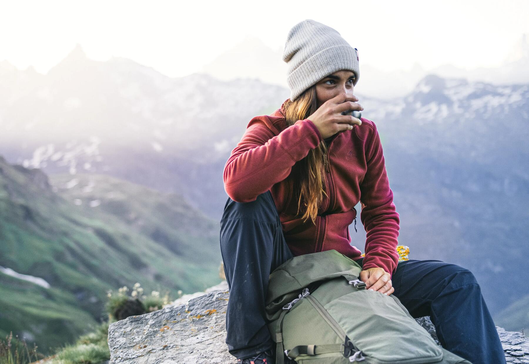 Woman sitting on a mountain top