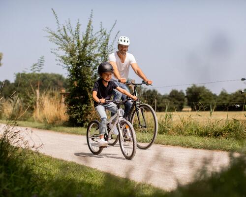 Father and son cycling in countryside