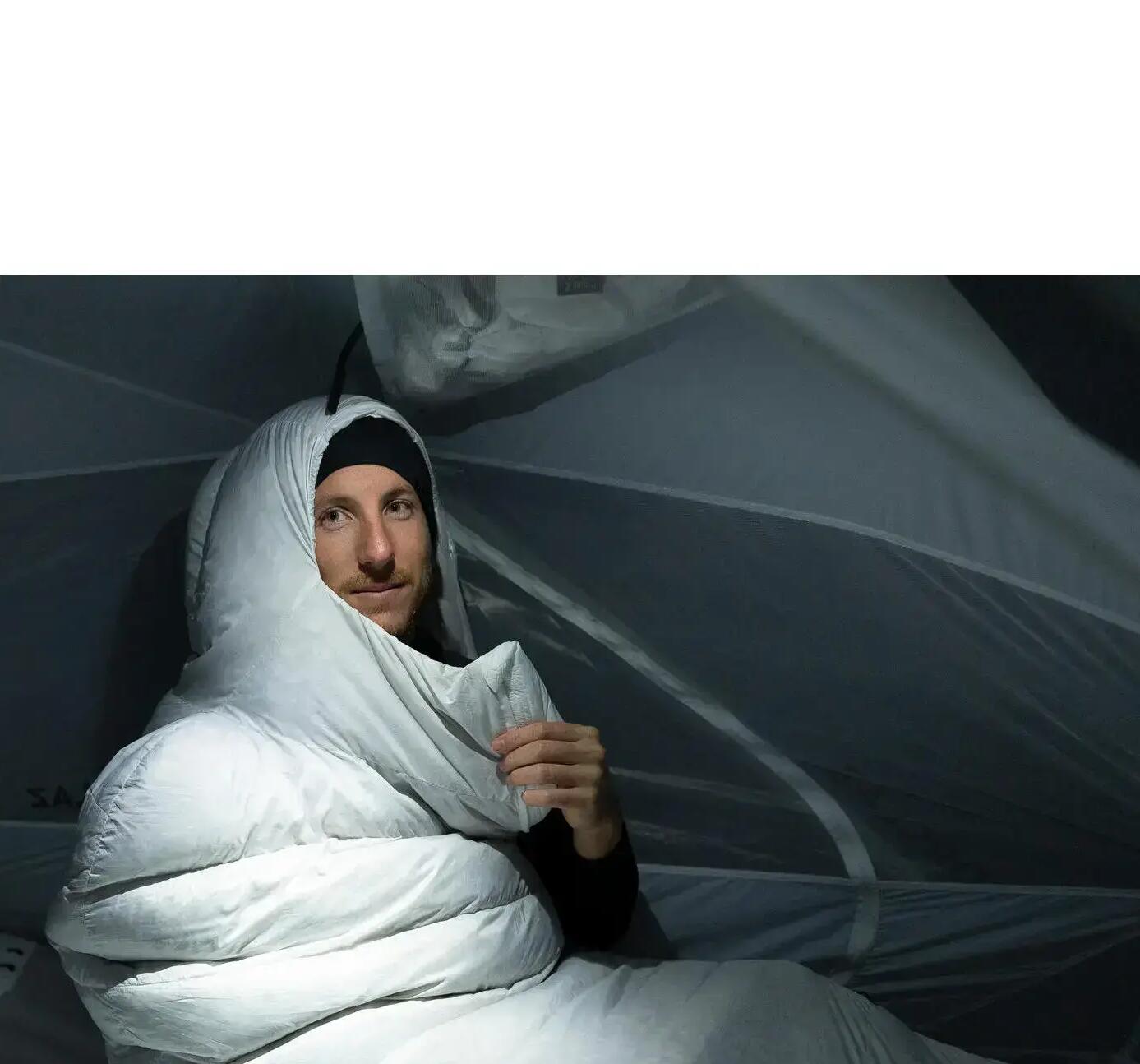 man in a white Sarcophagus sleeping bag