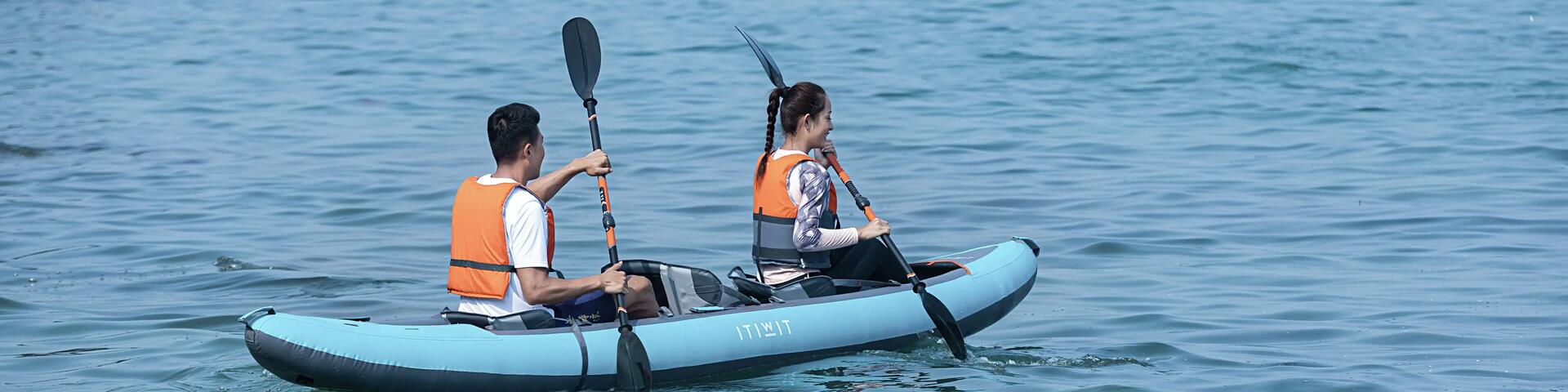 Two people rowing a kayak