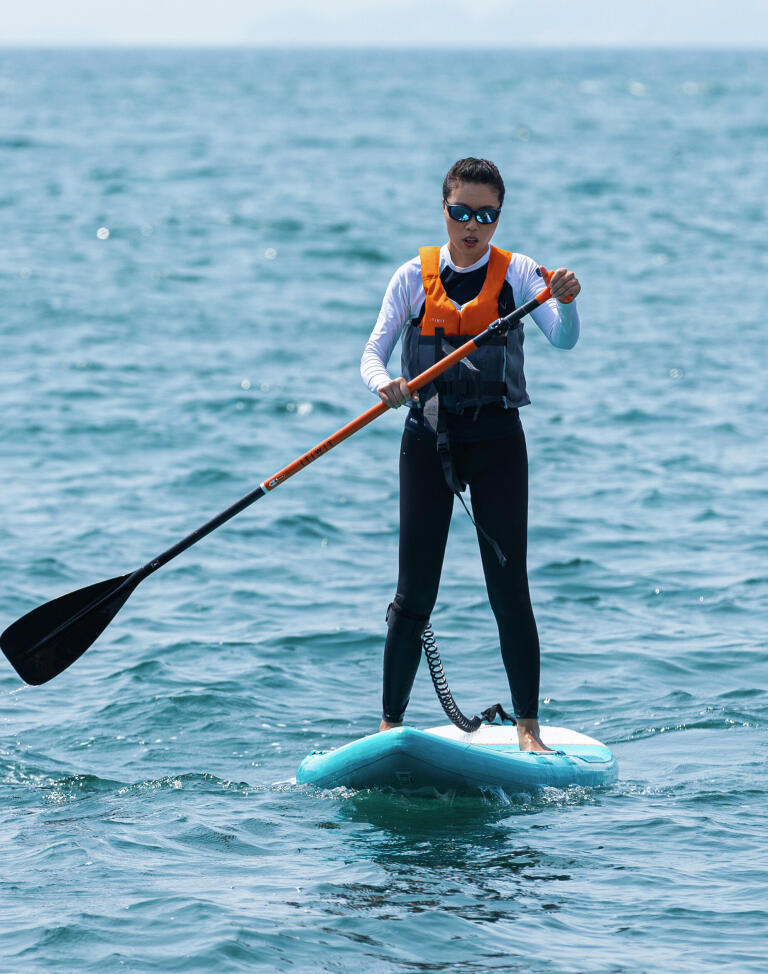 Woman is using sup in the sea