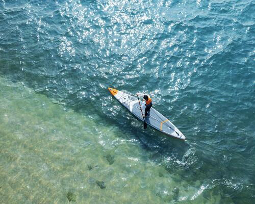 Birds-eye-view of person on SUP in sea