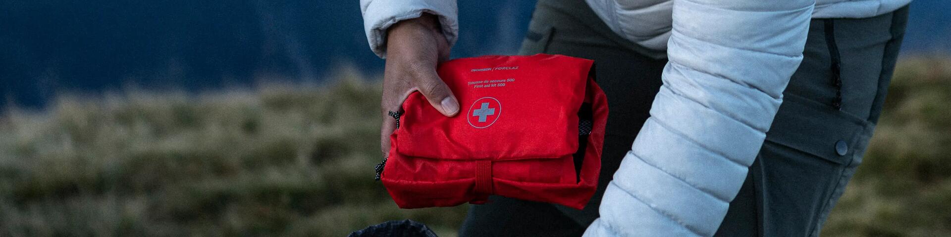 woman putting in a bag the first-aid kit 