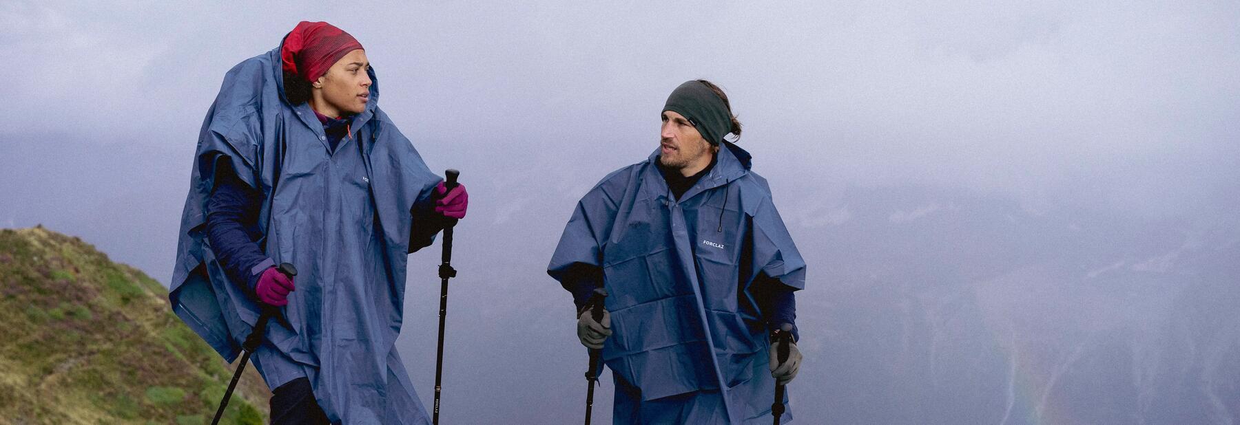 A couple hiking in wet weather wearing waterproof jackets