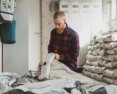 Man repairing a tent