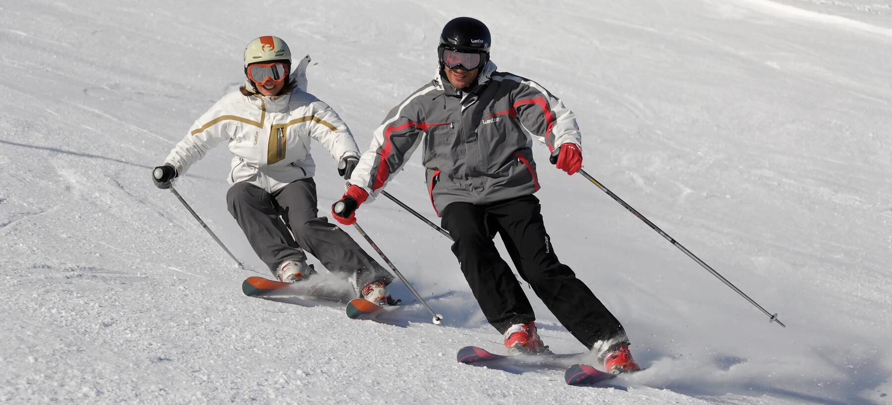Two skiers on an on-piste slope