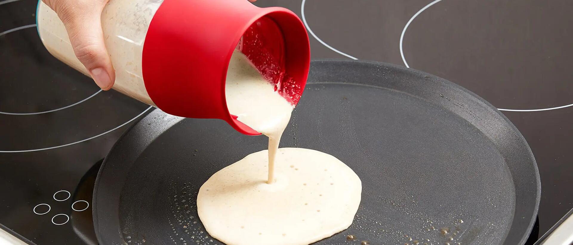Person pouring dough mix on pan