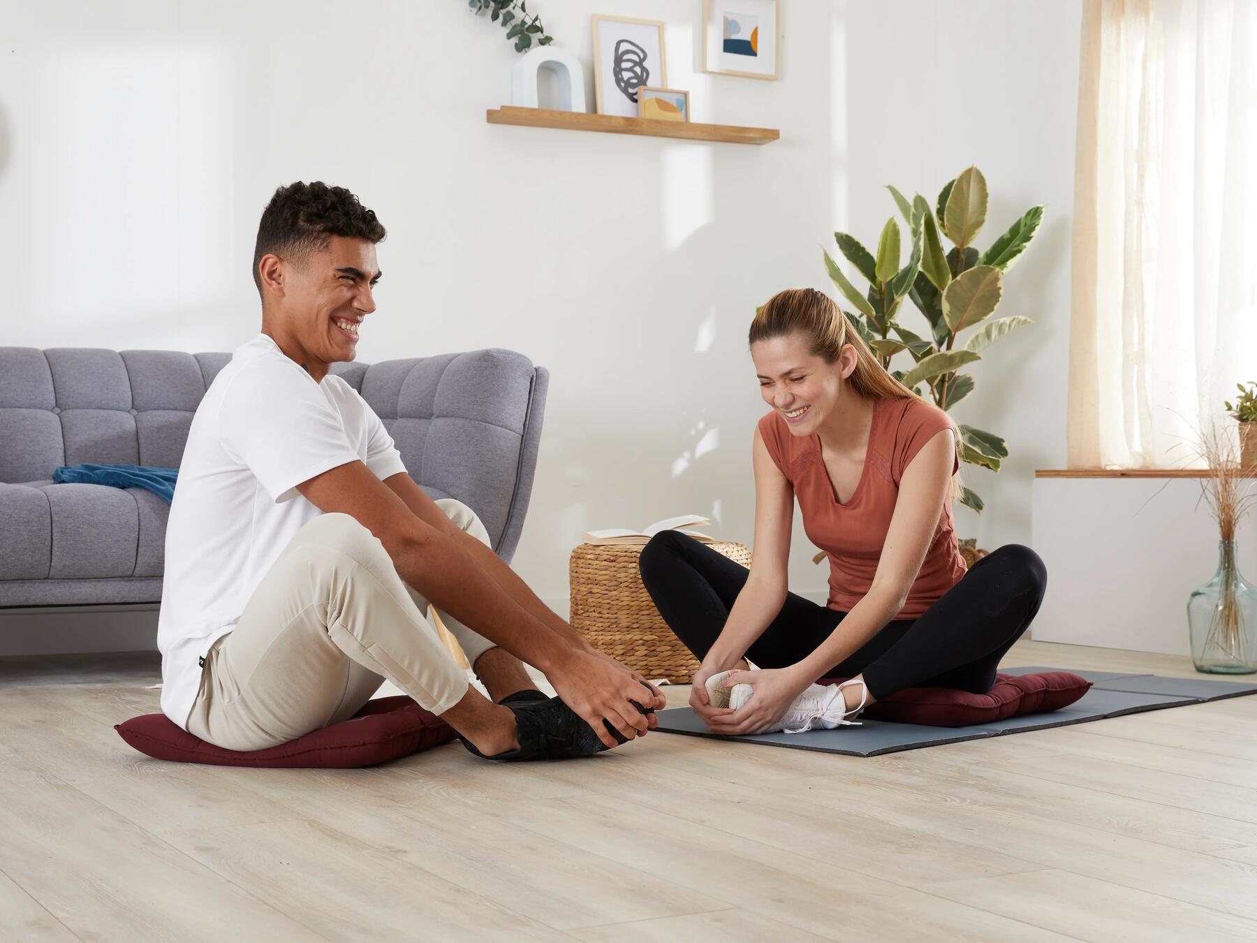 Man and woman doing stretches at home