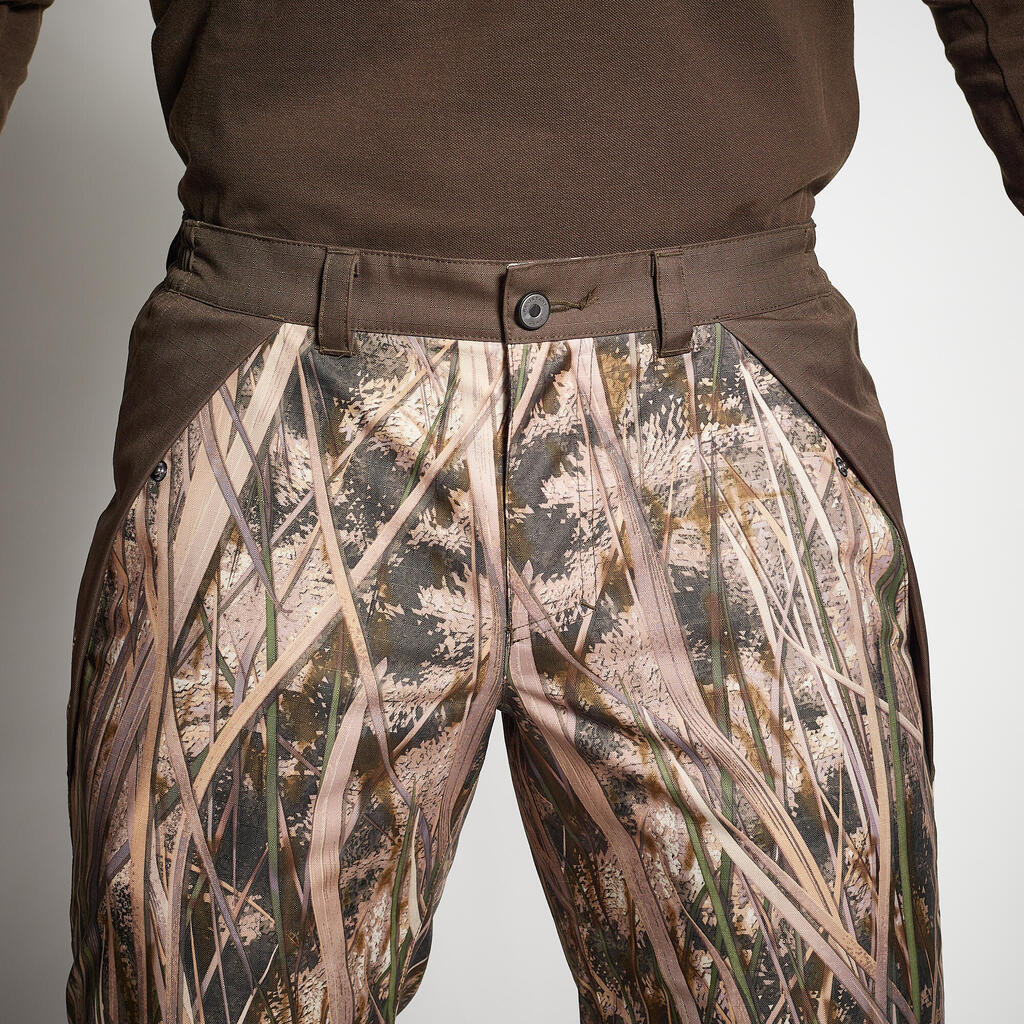 100 warm and waterproof hunting trousers with wetlands camouflage