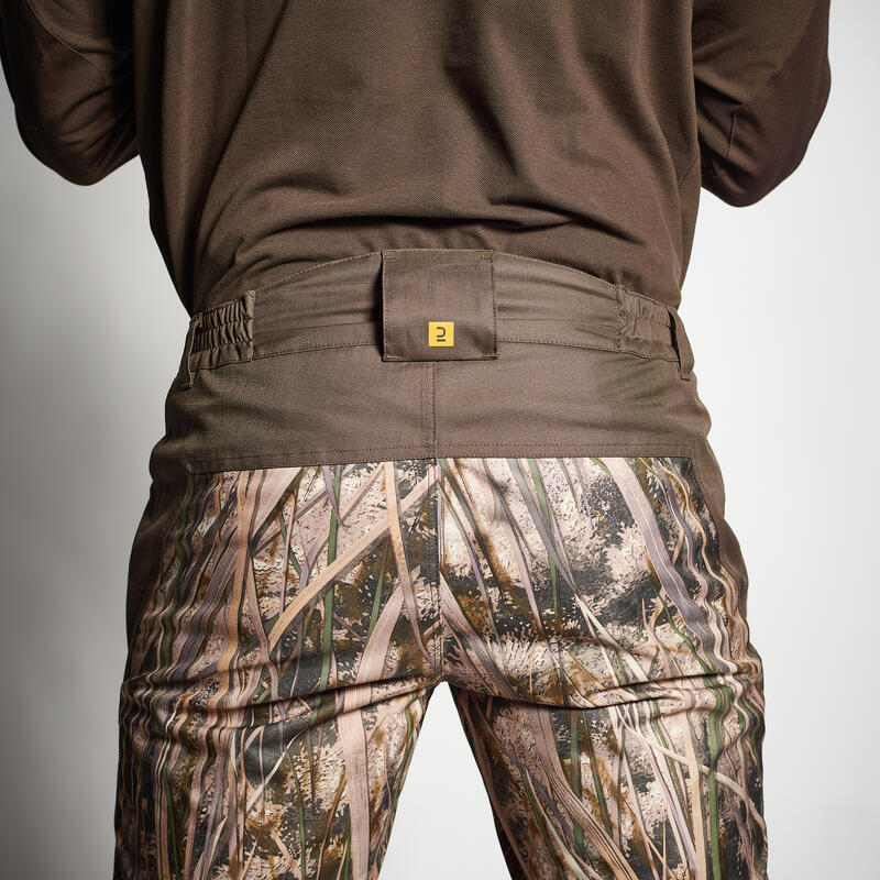 100 warm and waterproof hunting trousers with wetlands camouflage