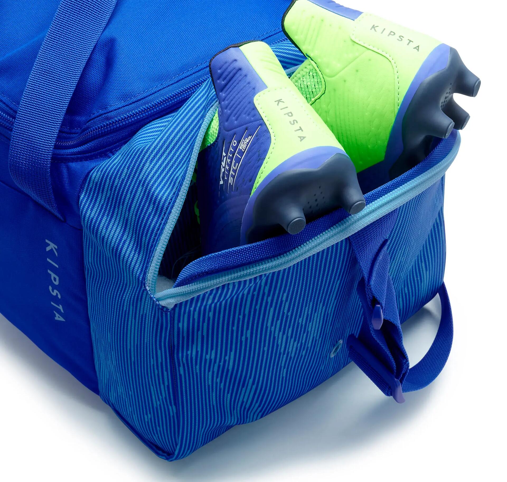 20L bright blue KIPSTA sports bag displaying the shoe compartment