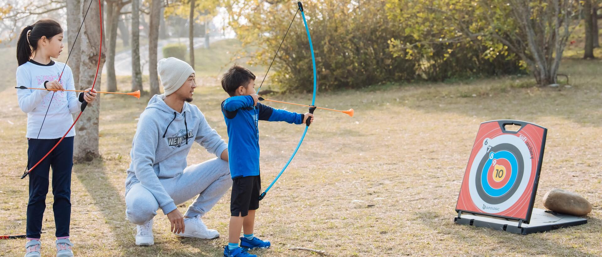 Kids shooting at archery target