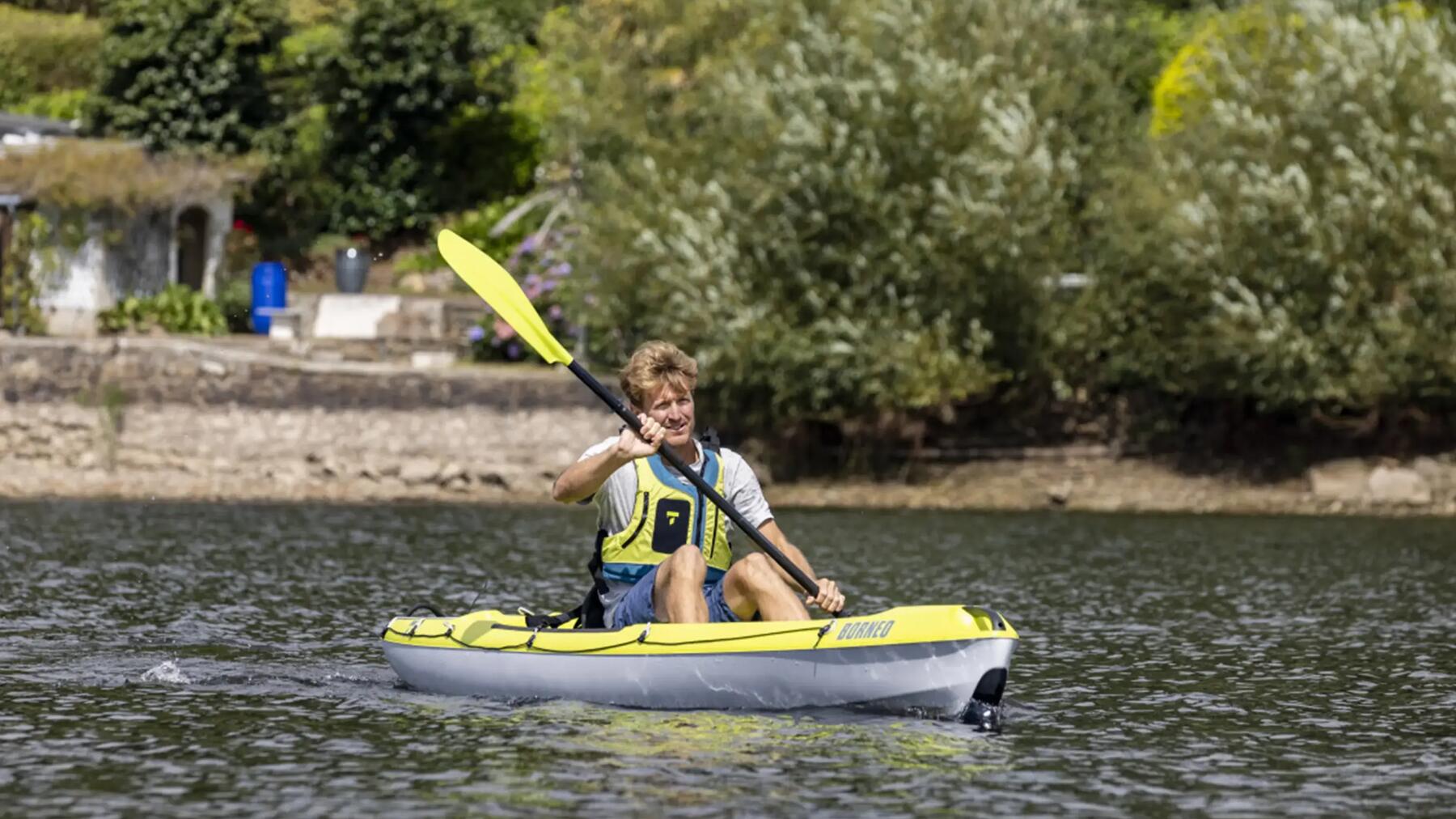 Ein Mann fährt Kajak auf dem Fluss
