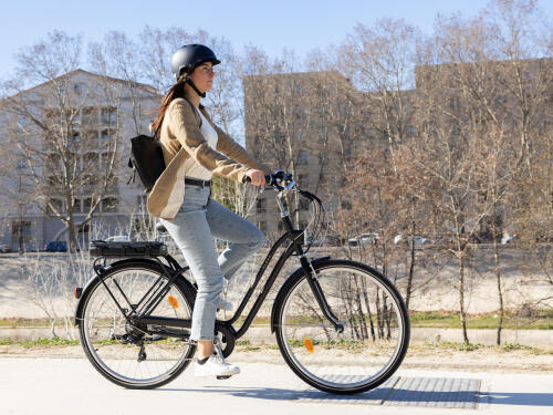 Mulher a andar de bicicleta elétrica na cidade