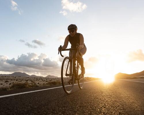 woman riding a bike at sunset