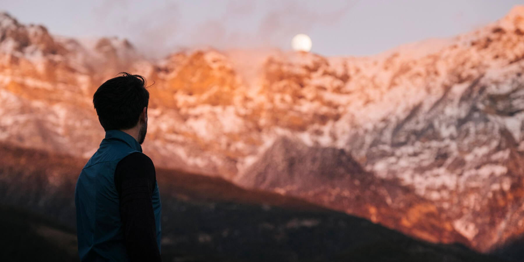 Picture of a man looking at the mountains
