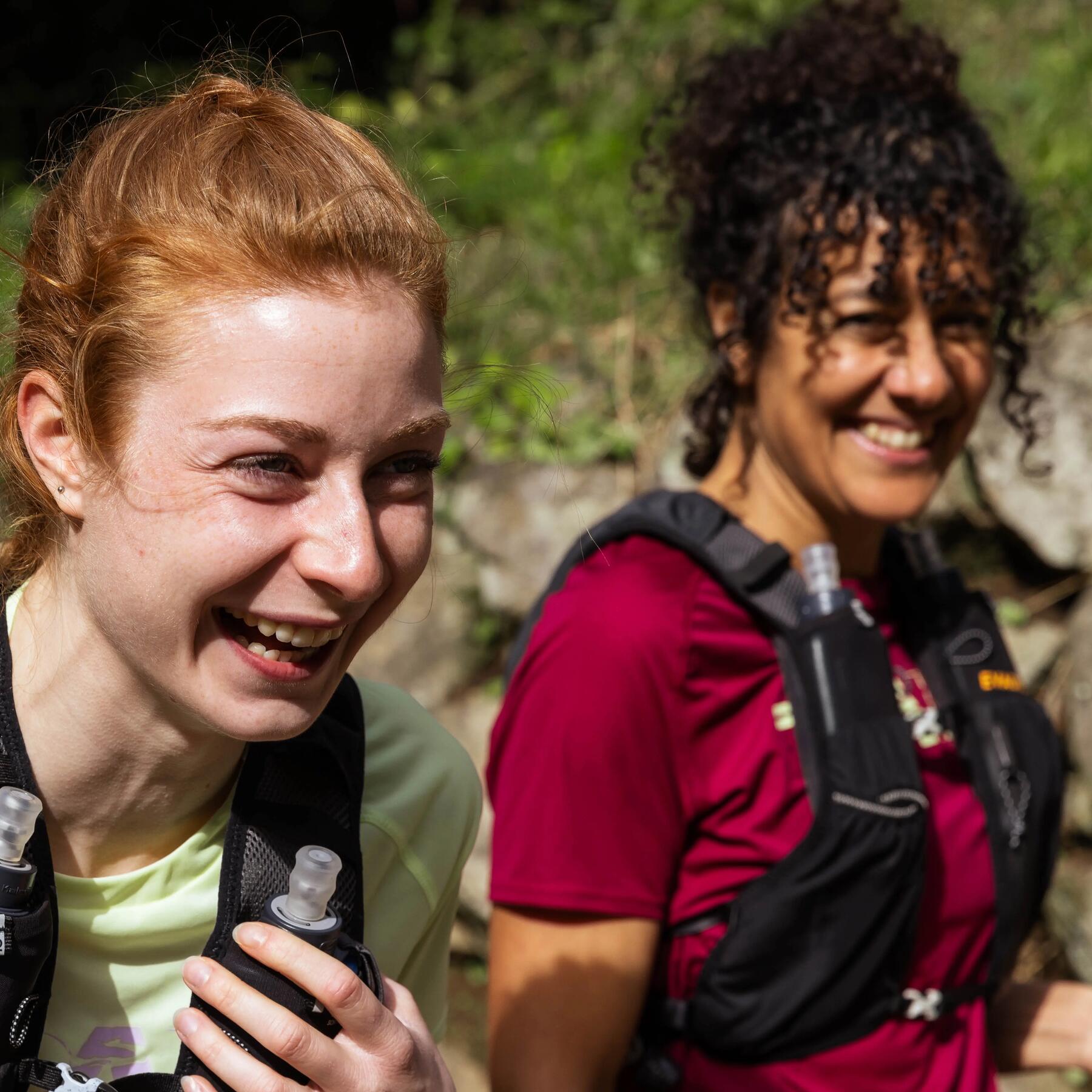 two women smiling while taking a walk