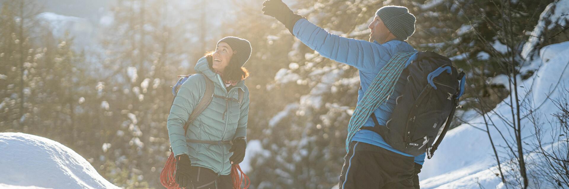 Man and woman out in the snow with their climbing ropes 
