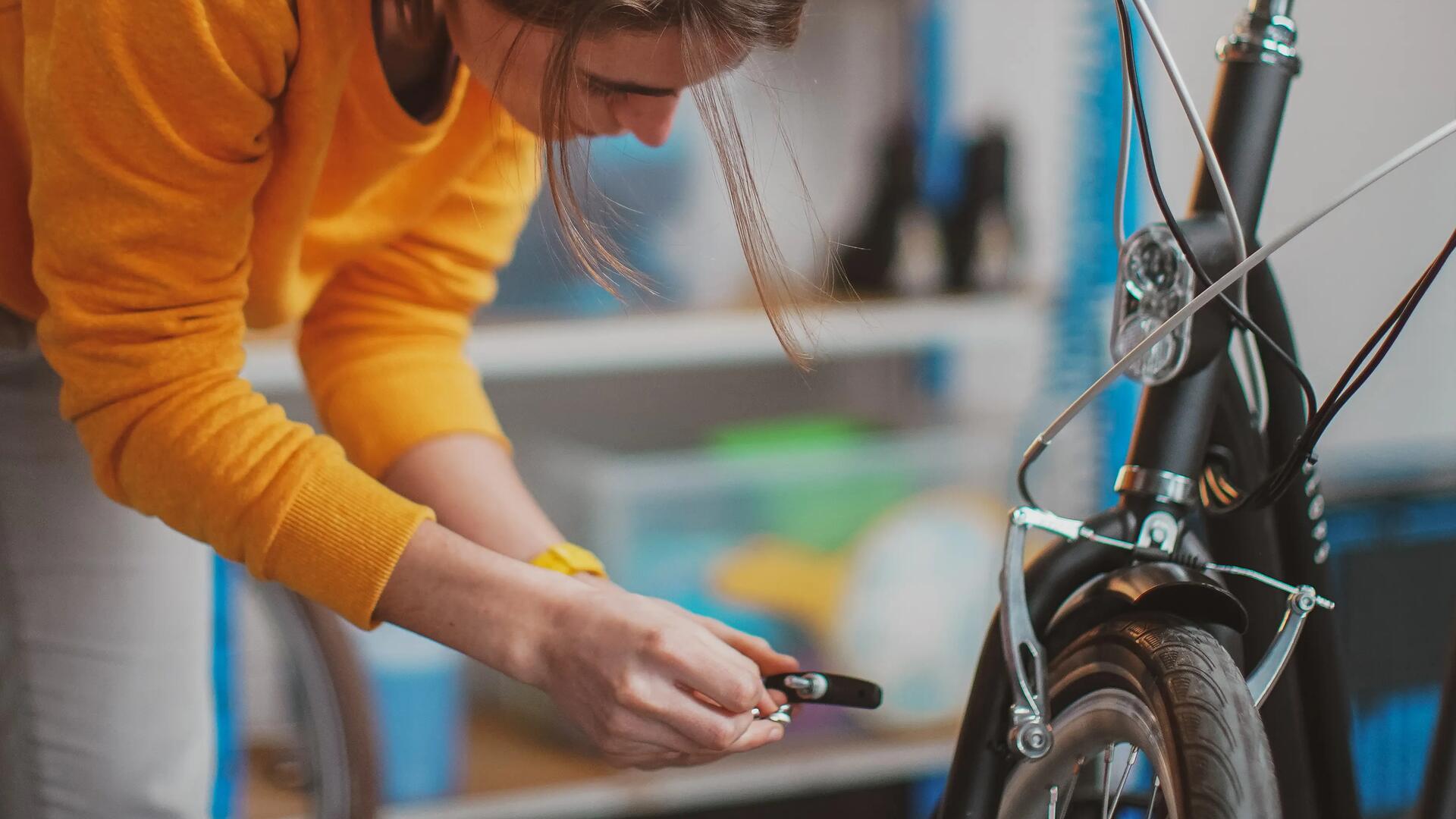 close-up of a lady changing bike brake pads