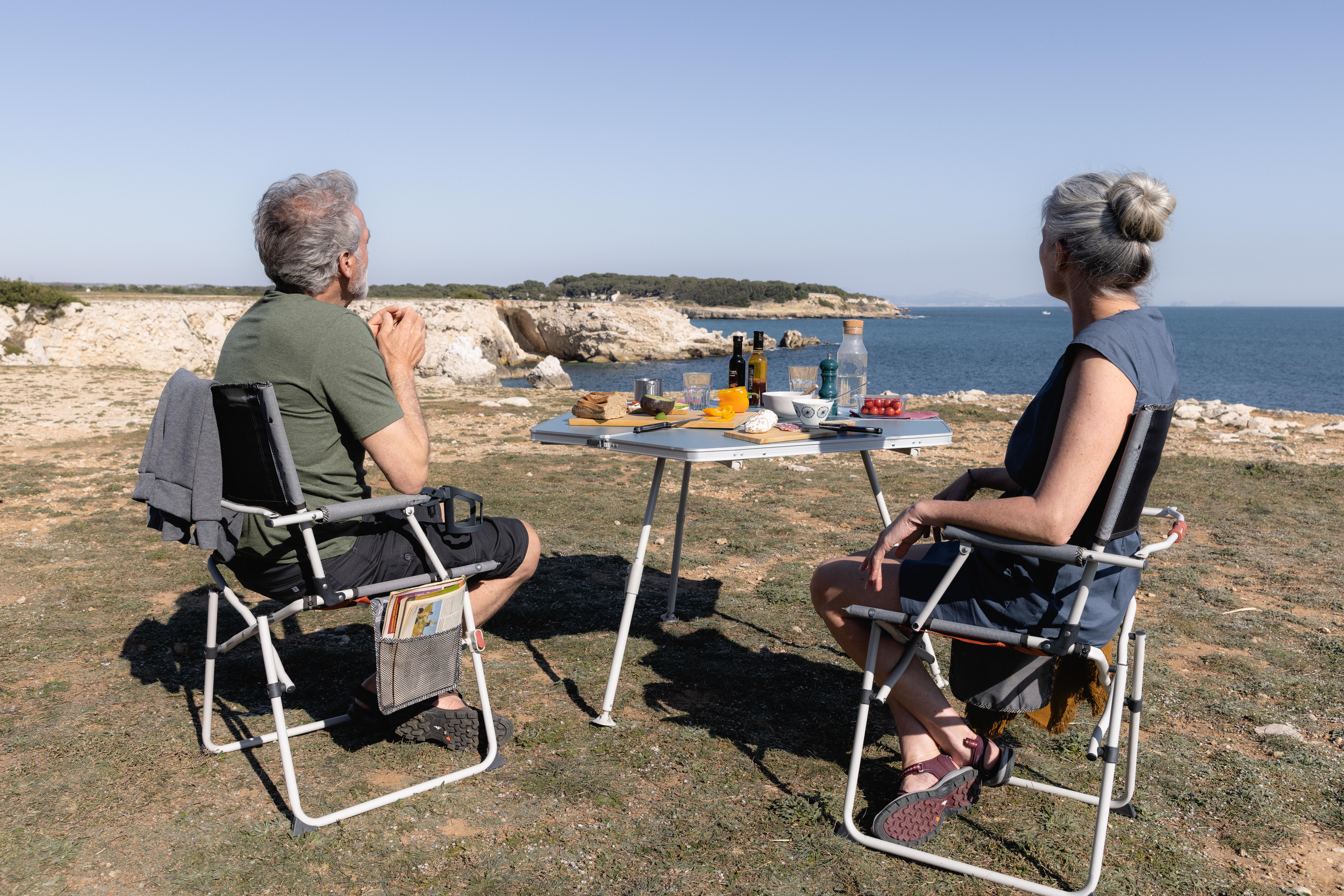 Portable picnic table set up for outdoor dining with a coastal view