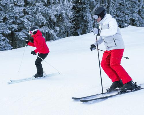 Two people skiing in snow