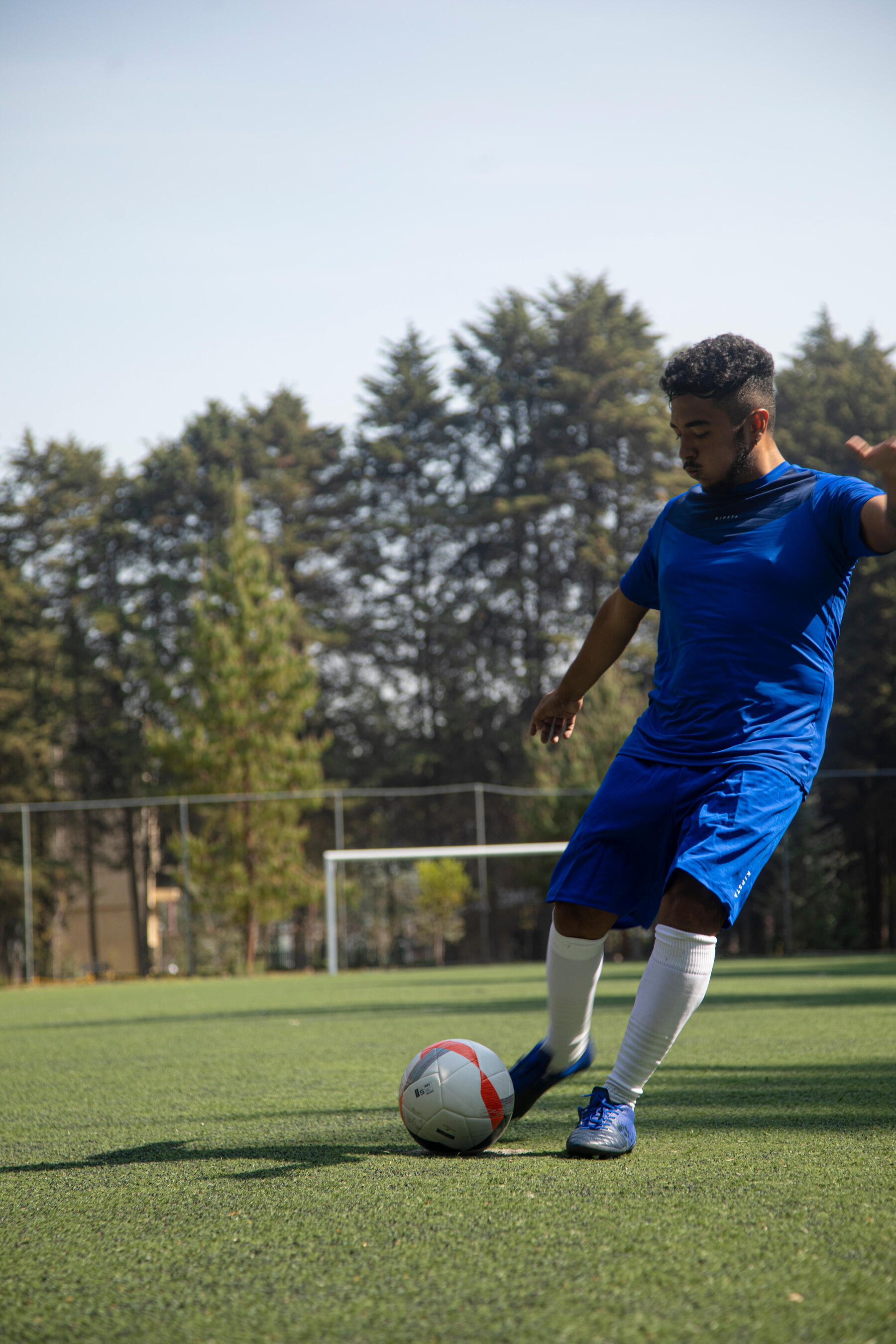 Mann schießt einen Ball und erkennt die Vorteile vom Fußball