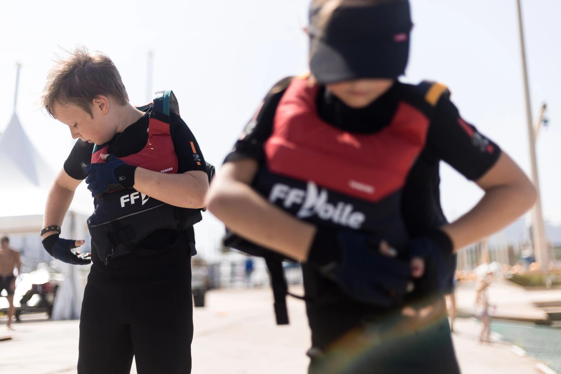 jeune marin qui attache son gilet de flottaison BA 50