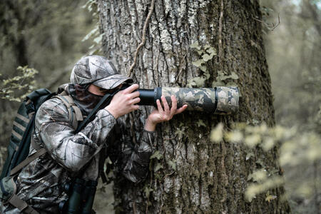 A photographer camouflaged to take photos of wildlife