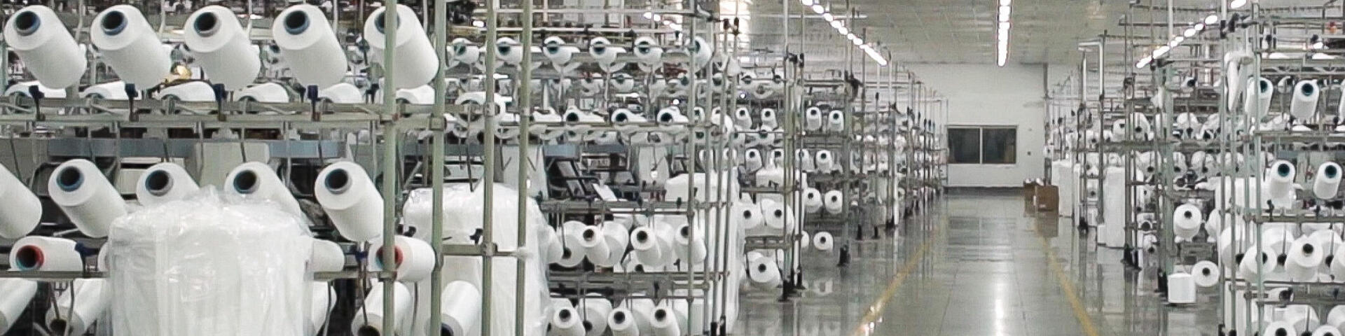 Picture of white bobbins in a warehouse