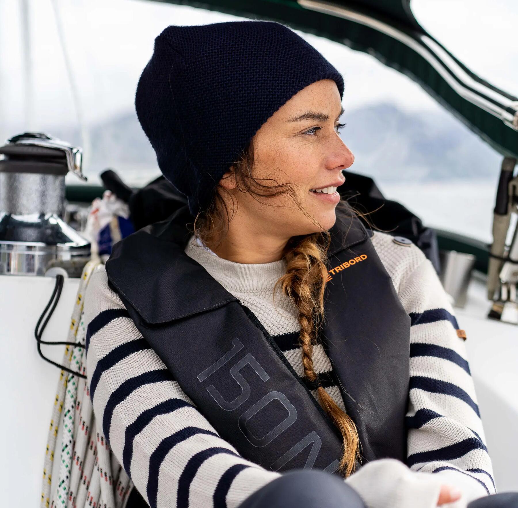 kobieta siedząca w łodzi ubrana w kamizelkę wypornościową