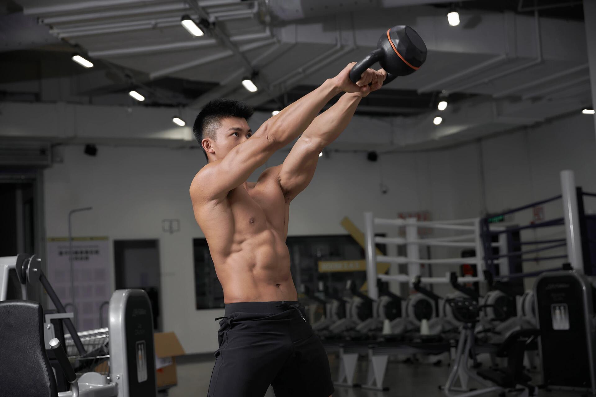 Mężczyzna ćwiczący z kettlebell na siłowni