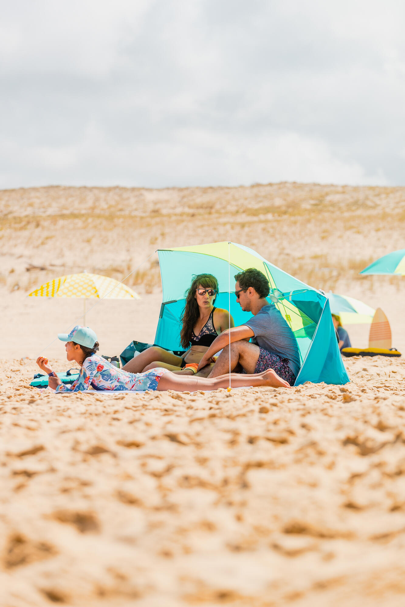 Family on the beach in a sun shelter